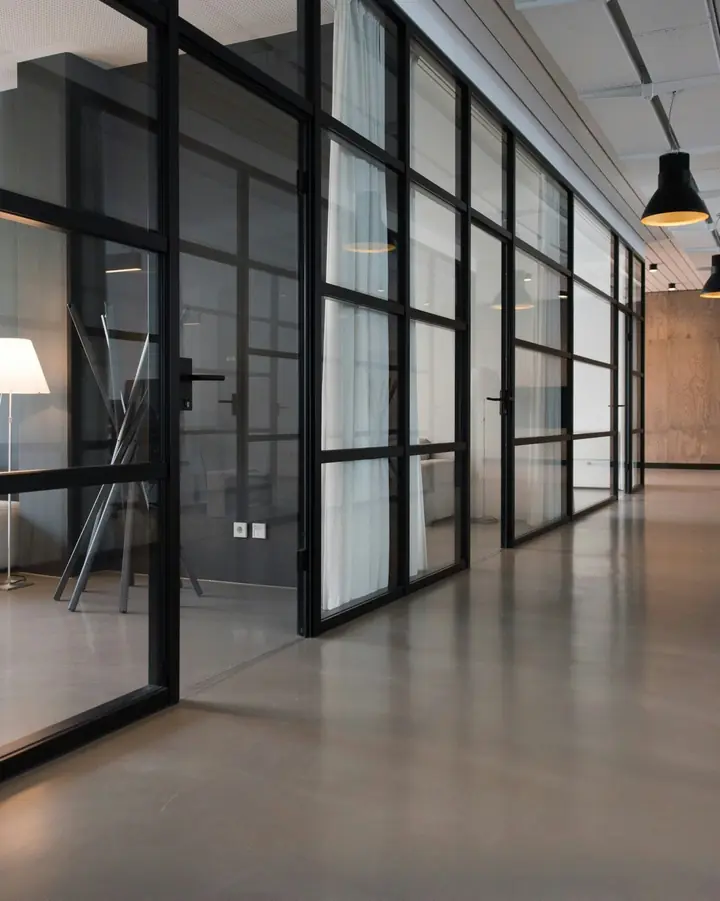 Furnished private office with glass partitions and natural light